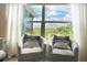 Cozy seating area by a large window with sheer curtains, offering a serene view of the outdoors at 591 Black Eagle Dr, Groveland, FL 34736