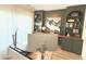 Comfortable home office with large monitors, wood floors, and built-in shelving at 591 Black Eagle Dr, Groveland, FL 34736