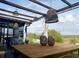 Inviting covered outdoor space featuring lounge seating, dining table, and decorative lighting at 591 Black Eagle Dr, Groveland, FL 34736