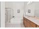 Bright bathroom featuring soaking tub, glass enclosed shower and double sink vanity at 6048 Topsail Rd, Lady Lake, FL 32159