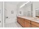 Well-lit bathroom with a soaking tub, double vanity, and elegant tile work at 6048 Topsail Rd, Lady Lake, FL 32159