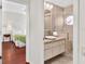 Bathroom with tiled walk-in shower and sink with an adjacent bedroom with hardwood floors at 6048 Topsail Rd, Lady Lake, FL 32159