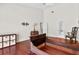 Large bedroom with hardwood floors, vintage furniture, and ensuite bathroom access at 6048 Topsail Rd, Lady Lake, FL 32159