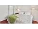Bright bedroom featuring hardwood floors, a comfortable bed, and wall sconces for soft lighting at 6048 Topsail Rd, Lady Lake, FL 32159
