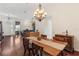 Charming dining room with a view, featuring a chandelier, wooden table, and an open layout at 6048 Topsail Rd, Lady Lake, FL 32159