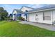 Charming home with a two-car garage, blue awnings, and a well-maintained lawn at 6048 Topsail Rd, Lady Lake, FL 32159