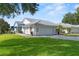 Charming home with a two-car garage, a brick driveway, and a well-maintained lawn at 6048 Topsail Rd, Lady Lake, FL 32159