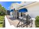 Stunning property with vibrant blue awnings over the windows and doors at 6048 Topsail Rd, Lady Lake, FL 32159