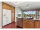 Kitchen with stainless steel appliances, granite countertops, wood cabinets and a view of the golf course at 6048 Topsail Rd, Lady Lake, FL 32159