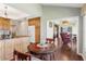 Cozy breakfast nook with golf course view in an open floor plan, hardwood floors, and wood cabinets at 6048 Topsail Rd, Lady Lake, FL 32159