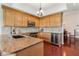 Spacious kitchen with wood cabinets, granite countertops, stainless steel appliances, and hardwood floors at 6048 Topsail Rd, Lady Lake, FL 32159