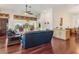 Spacious living room with hardwood floors, large windows offering scenic views, and comfortable seating at 6048 Topsail Rd, Lady Lake, FL 32159