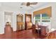 Home office with hardwood floors, built in desk, vintage cabinets, and large window overlooking the landscape at 6048 Topsail Rd, Lady Lake, FL 32159