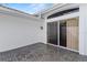Private outdoor patio featuring neutral brick pavers and a sliding glass door entryway at 6048 Topsail Rd, Lady Lake, FL 32159