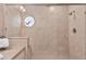 Tiled shower with unique window and glass door at 6048 Topsail Rd, Lady Lake, FL 32159