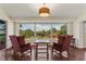 Bright sitting area with large windows overlooking lush greenery, complete with comfortable chairs and lighting at 6048 Topsail Rd, Lady Lake, FL 32159