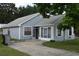 Charming single-story home with blue siding, screened porch, and well-maintained landscaping at 610 Swallow Ct, Apopka, FL 32712