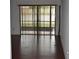 Spacious living room with sliding doors and hardwood floors at 610 Swallow Ct, Apopka, FL 32712