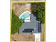 An overhead view showcases a home with a pool and solar panels in a neatly kept yard at 6221 Ambassador Dr, Orlando, FL 32808