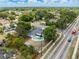 Aerial view of a home with a backyard pool and lush landscaping, next to a street with moving traffic at 6221 Ambassador Dr, Orlando, FL 32808