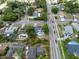 Aerial view of a neighborhood featuring homes with pools and solar panels alongside well-maintained roads at 6221 Ambassador Dr, Orlando, FL 32808