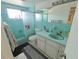 A full bathroom with combined shower and bathtub, white toilet, and vanity sink, all in light blue colors at 6221 Ambassador Dr, Orlando, FL 32808