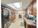 Kitchen features wood cabinets, neutral countertops, modern appliances, and tiled floor at 6221 Ambassador Dr, Orlando, FL 32808