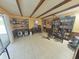 An open living room with tile floors, a weight rack, bookshelves, and an outdoor view through glass doors at 6221 Ambassador Dr, Orlando, FL 32808