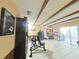 The spacious living room has tile flooring, wood beam ceilings, and sliding glass doors to the outside at 6221 Ambassador Dr, Orlando, FL 32808