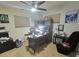 A home office equipped with a desk, chair, ceiling fan, and a window at 6221 Ambassador Dr, Orlando, FL 32808