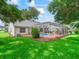 Beautiful backyard showcasing a screened-in pool area and lush green lawn with landscaping at 628 San Pedro Dr, The Villages, FL 32159