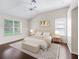 Serene bedroom with hardwood floors, complemented by bright natural light and tasteful decor at 628 San Pedro Dr, The Villages, FL 32159