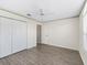 Clean bedroom featuring wood floors, ceiling fan, and closet at 628 San Pedro Dr, The Villages, FL 32159