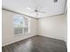 Cozy bedroom with wood floors, ceiling fan, and a large window at 628 San Pedro Dr, The Villages, FL 32159