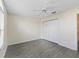 Bedroom with gray wood-look flooring, white walls, closet, and ceiling fan at 628 San Pedro Dr, The Villages, FL 32159