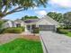 Charming single-story home with a well-manicured lawn, decorative driveway, and inviting facade at 628 San Pedro Dr, The Villages, FL 32159