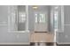 Inviting home foyer with white tile flooring, pillars, and natural light at 628 San Pedro Dr, The Villages, FL 32159