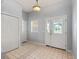 Bright foyer featuring tile floors, double front doors, and a convenient coat closet at 628 San Pedro Dr, The Villages, FL 32159
