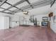 Spacious garage interior featuring ample storage, laundry area, and painted floor at 628 San Pedro Dr, The Villages, FL 32159