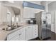 Bright kitchen featuring stainless steel appliances, white cabinetry and ample counter space at 628 San Pedro Dr, The Villages, FL 32159