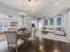 Open-concept living and dining area with hardwood floors and stylish furnishings, perfect for entertaining at 628 San Pedro Dr, The Villages, FL 32159