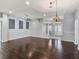 Room featuring beautiful hardwood floors, modern lighting, and a welcoming entrance. Perfect for relaxation at 628 San Pedro Dr, The Villages, FL 32159