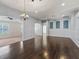 Spacious room with hardwood floors, neutral paint, and ample natural light. Ready for your personal touch at 628 San Pedro Dr, The Villages, FL 32159