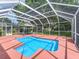 Relaxing screened-in pool area with an umbrella table, ideal for outdoor entertaining and enjoyment at 628 San Pedro Dr, The Villages, FL 32159