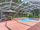 Screened pool with seating and gazebo in backyard at 628 San Pedro Dr, The Villages, FL 32159