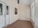 Cozy covered porch featuring neutral walls and flooring, offering a relaxing spot at 628 San Pedro Dr, The Villages, FL 32159
