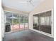 Bright sunroom with sliding glass doors view of the screened pool at 628 San Pedro Dr, The Villages, FL 32159