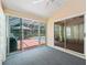 Enclosed sunroom with carpet and multiple sliding doors leading to backyard pool area at 628 San Pedro Dr, The Villages, FL 32159