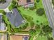 Aerial view of home with manicured landscaping, rock garden, and a well-maintained green lawn at 654 Poinsett Ct, The Villages, FL 32162