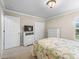 Bedroom with white furniture, TV, and closet for ample storage at 654 Poinsett Ct, The Villages, FL 32162